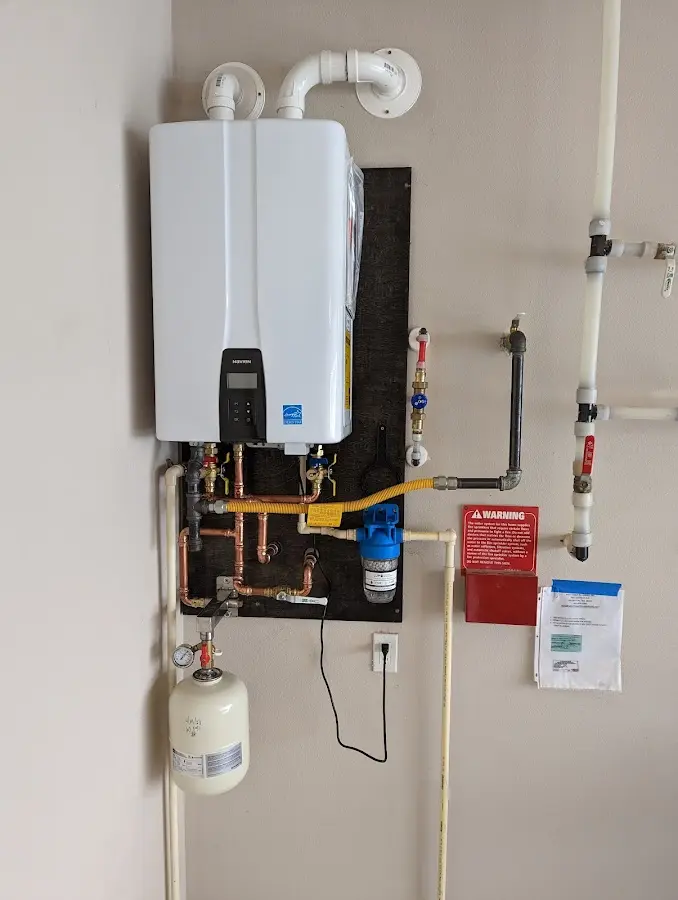Professional plumber installing copper piping in a Keyport home